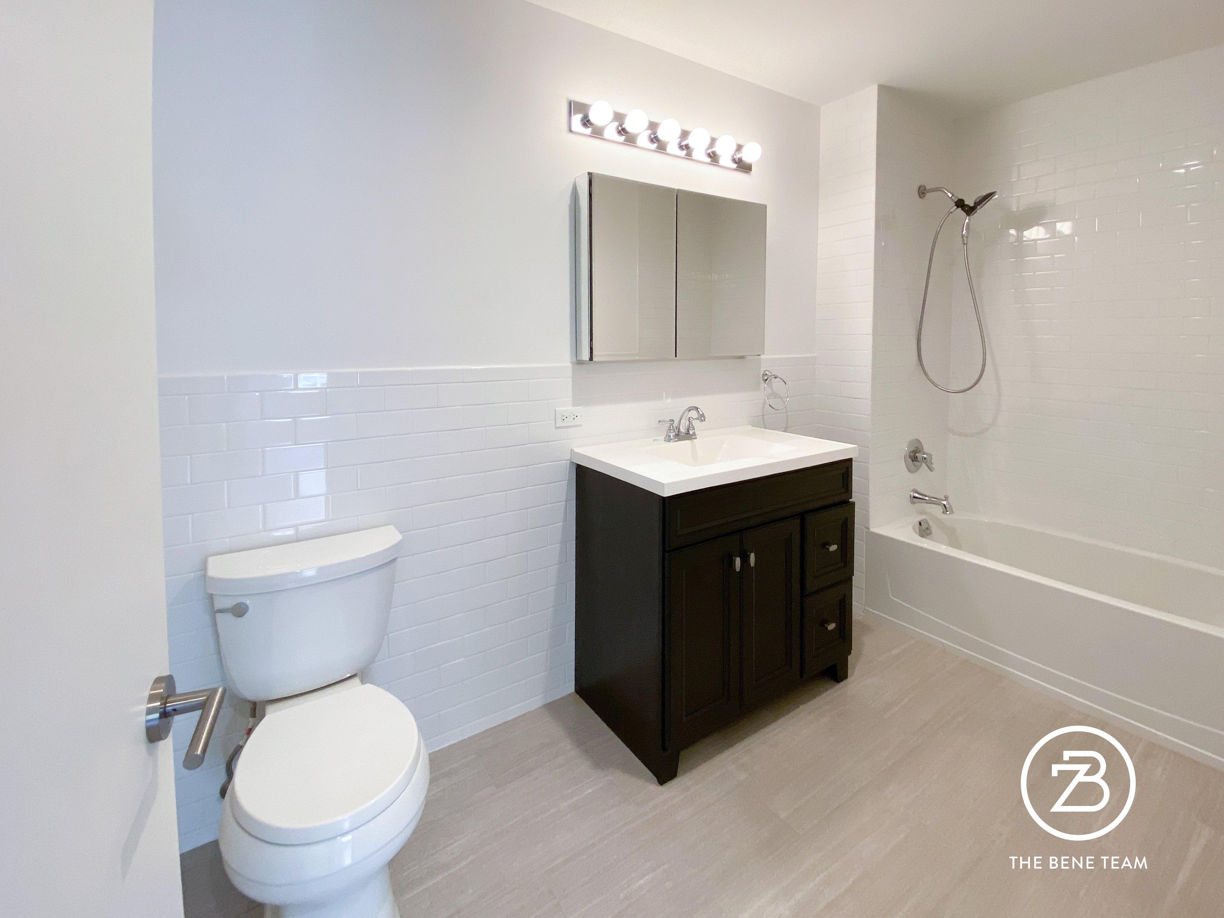 14-25 27th Avenue, Unit 3A Queens, NY 11102 - Photo 5 of 9 a bathroom with a sink a toilet and a mirror