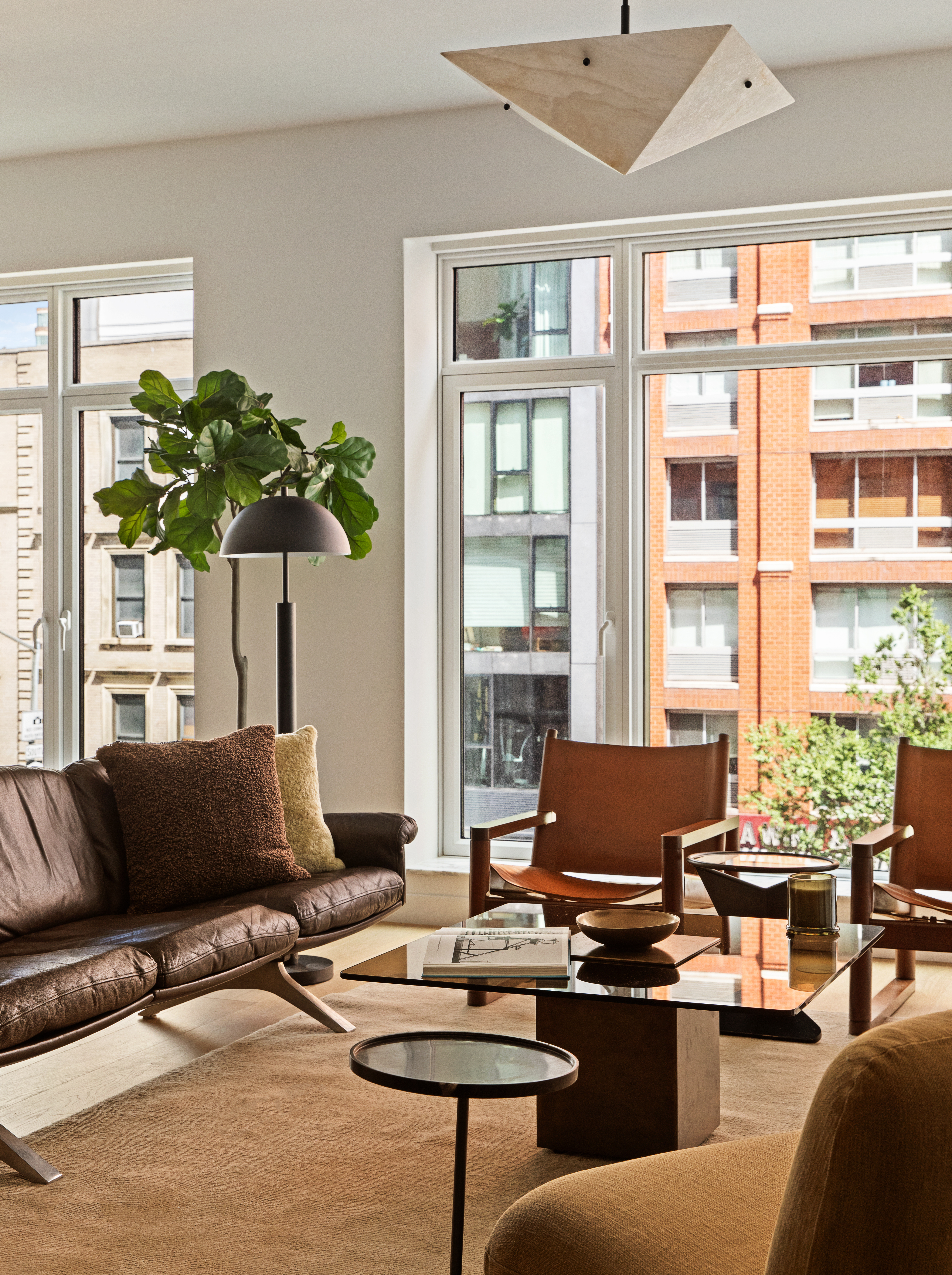 555 West 22nd Street, Unit 4CE Manhattan, NY 10011 - Photo 3 of 21 a living room with furniture and a potted plant