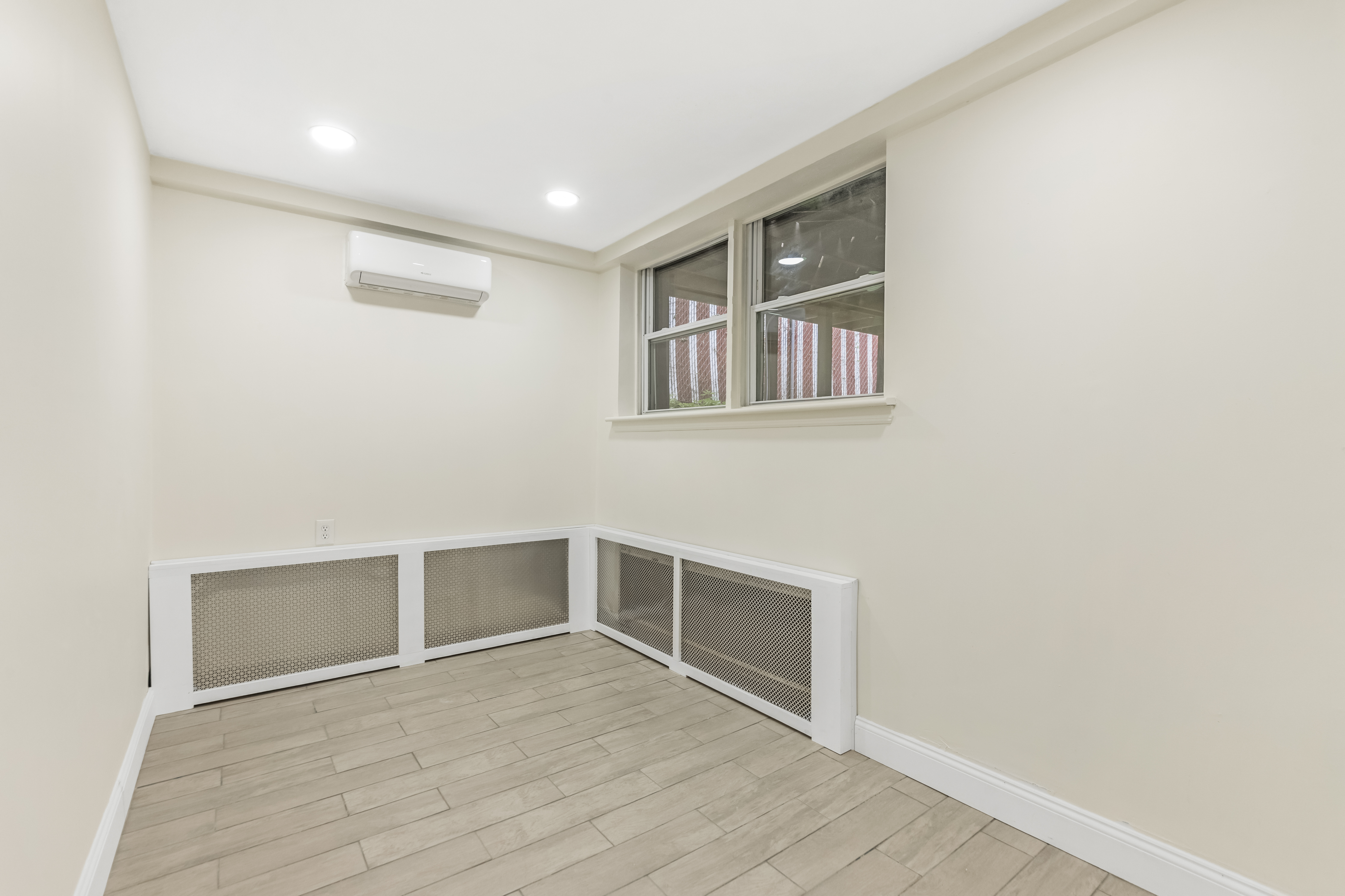 185 Oxford Street Brooklyn, NY 11235 - Photo 8 of 17 a view of an empty room with wooden floor and a window