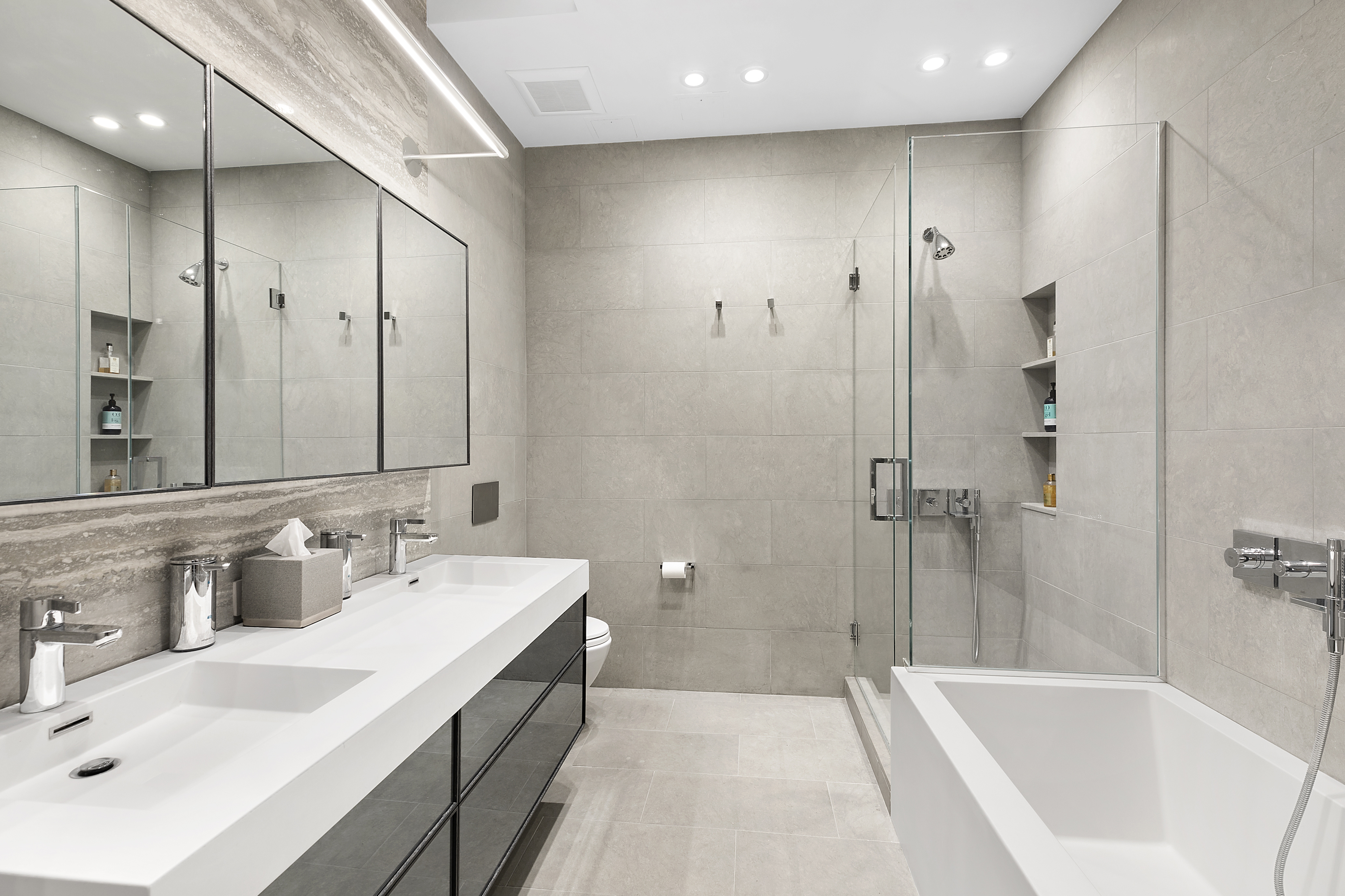 88 Lexington Avenue, Unit 802 Manhattan, NY 10016 - Photo 6 of 22 a spacious bathroom with a bathtub sink mirror and shower