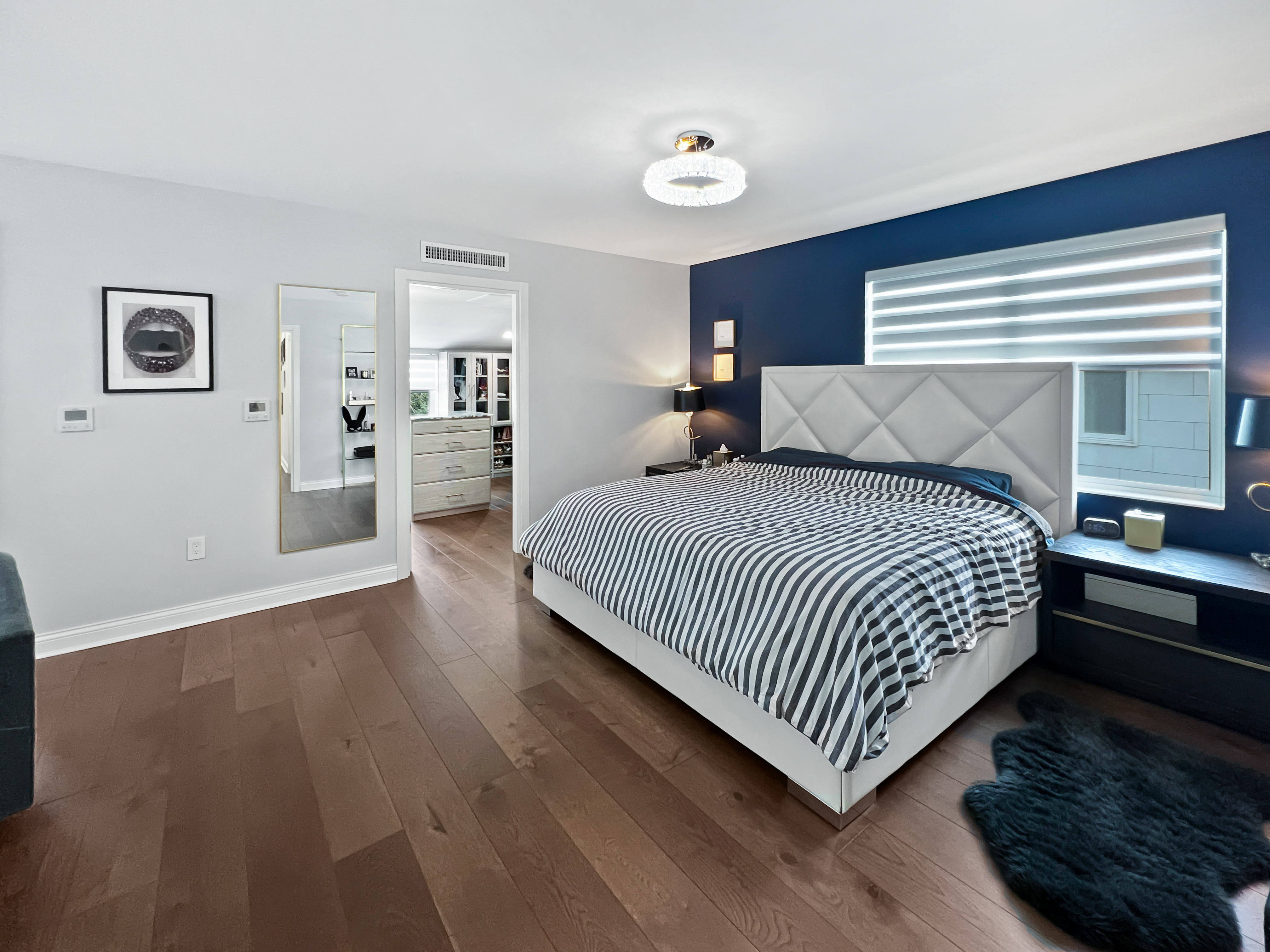 5021 Surf Avenue Brooklyn, NY 11224 - Photo 11 of 32 a bedroom with a bed and dresser with wooden floor