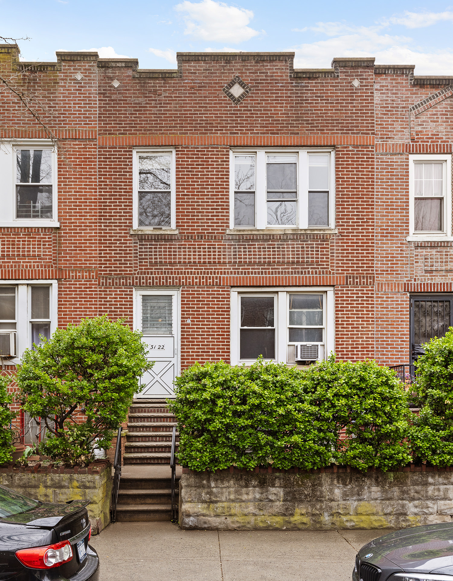 31-22 36th Street Queens, NY 11106 - Photo 1 of 10 a front view of a house with a yard