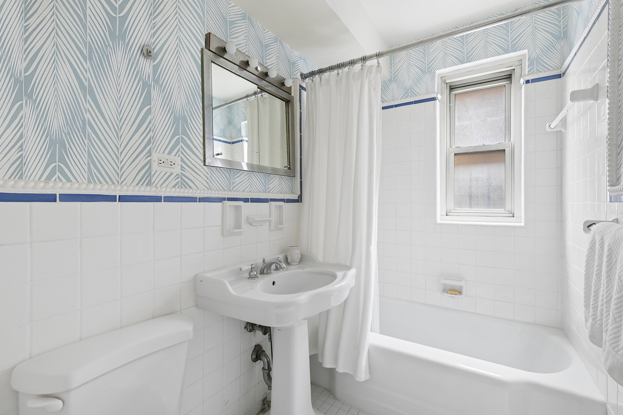 1199 Park Avenue, Unit 2F Manhattan, NY 10128 - Photo 8 of 12 a bathroom with a sink a mirror and a bathtub
