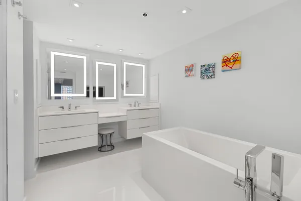 a large white kitchen with stainless steel appliances lots of counter top space