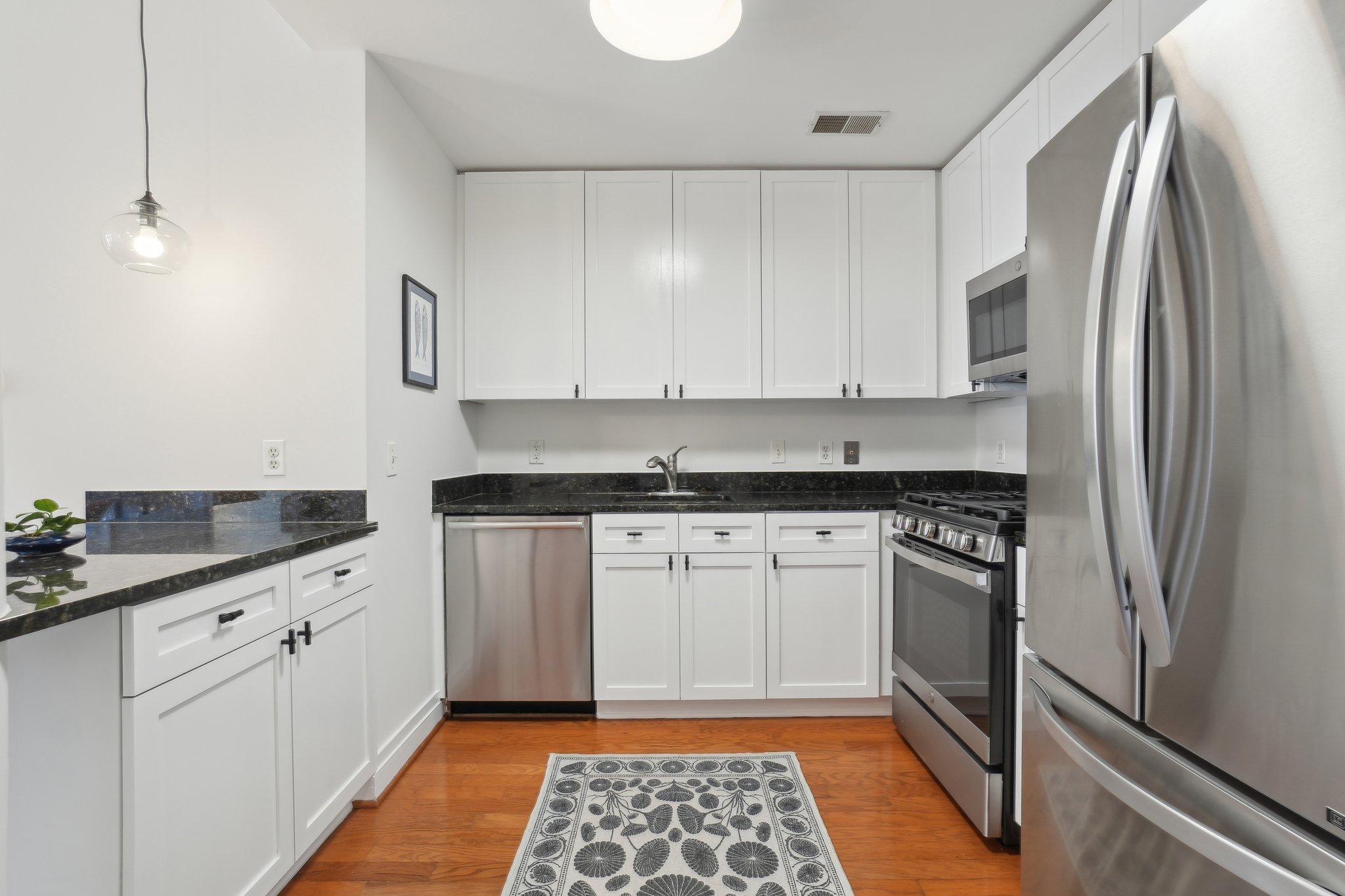 2120 Vermont Avenue Northwest, Unit 309 Washington, DC 20001 - Photo 9 of 26 a kitchen with granite countertop a sink stove and refrigerator