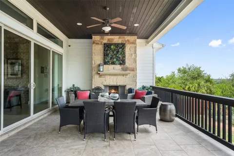 a view of a patio with a dining table and chairs