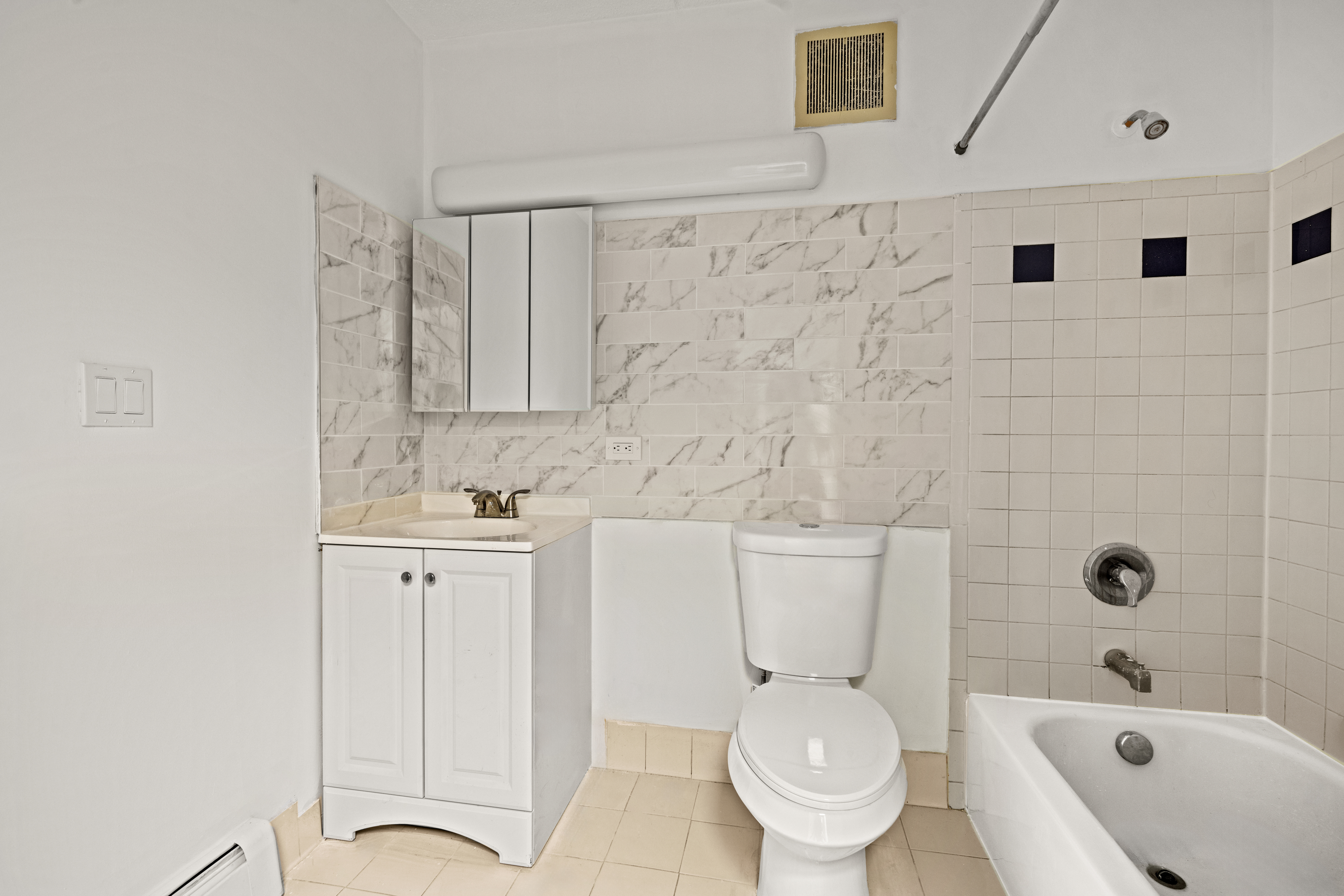 175 Eldert Street, Unit 2 Brooklyn, NY 11207 - Photo 9 of 15 a white toilet sitting next to a bathroom sink