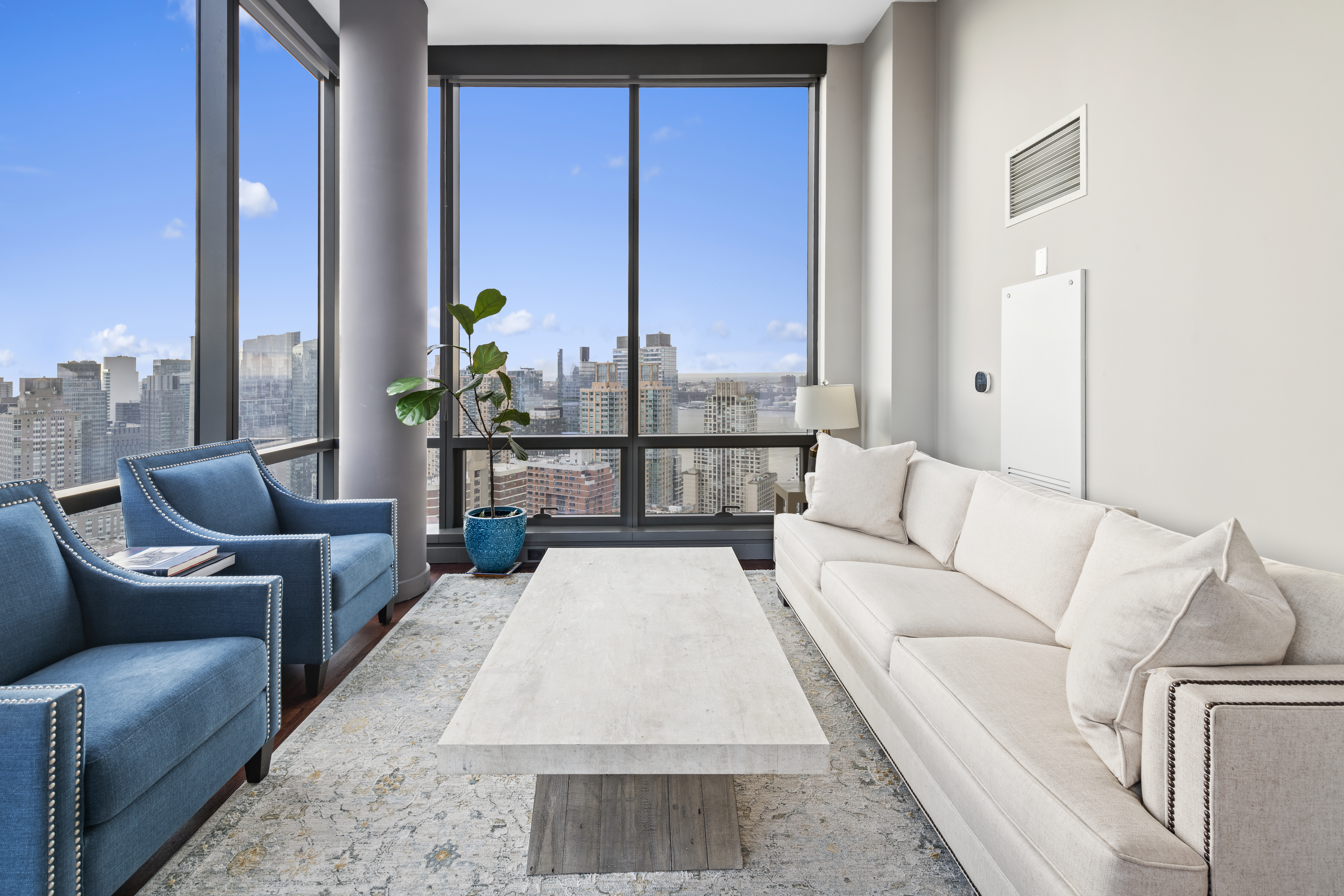 200 West 67th Street, Unit 32C Manhattan, NY 10023 - Photo 2 of 17 a living room with furniture and a potted plant