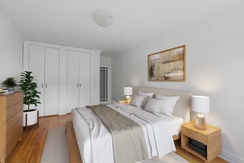 a bedroom with a bed and a potted plant