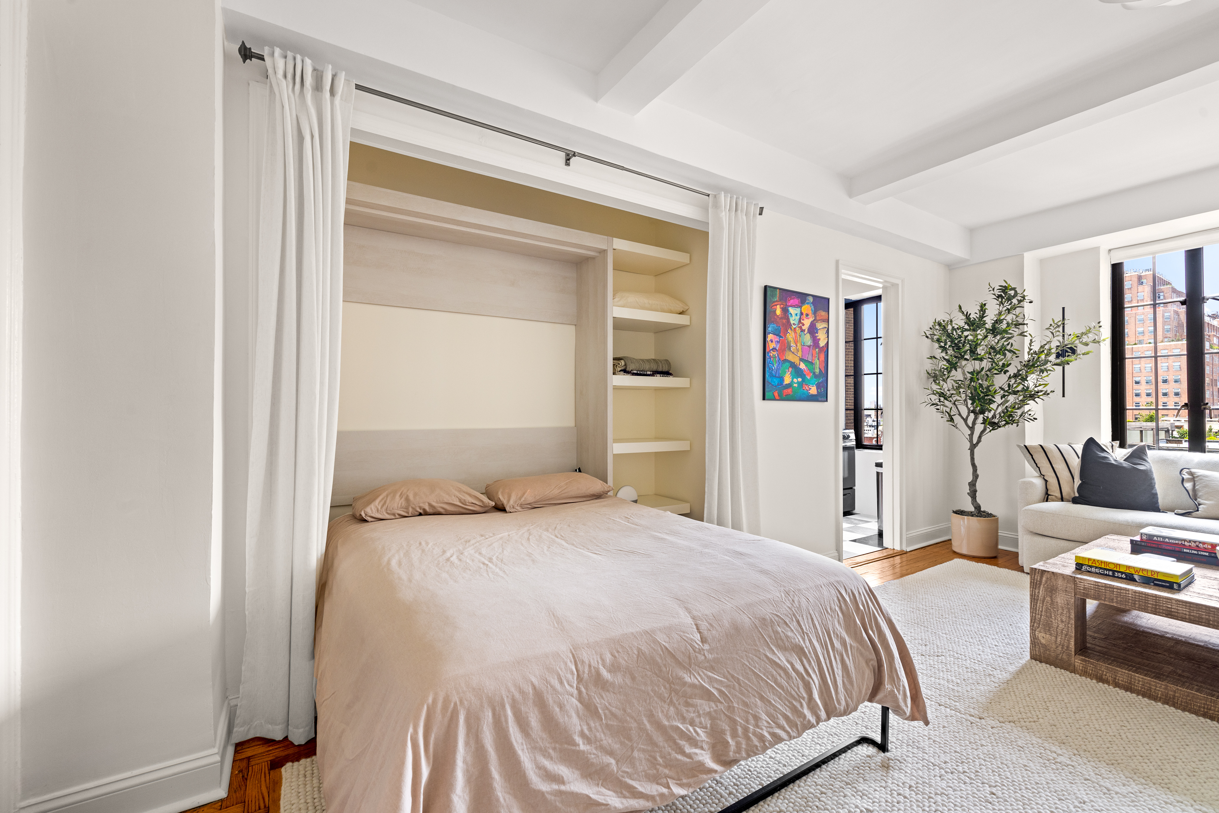 201 West 16th Street, Unit 8F Manhattan, NY 10011 - Photo 3 of 11 a bedroom with a bed and a couch