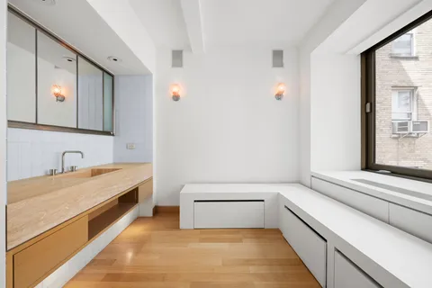 a bathroom with a tub sink and mirror