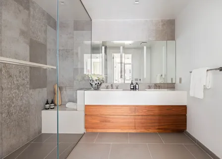 a bathroom with a tub sink and mirror