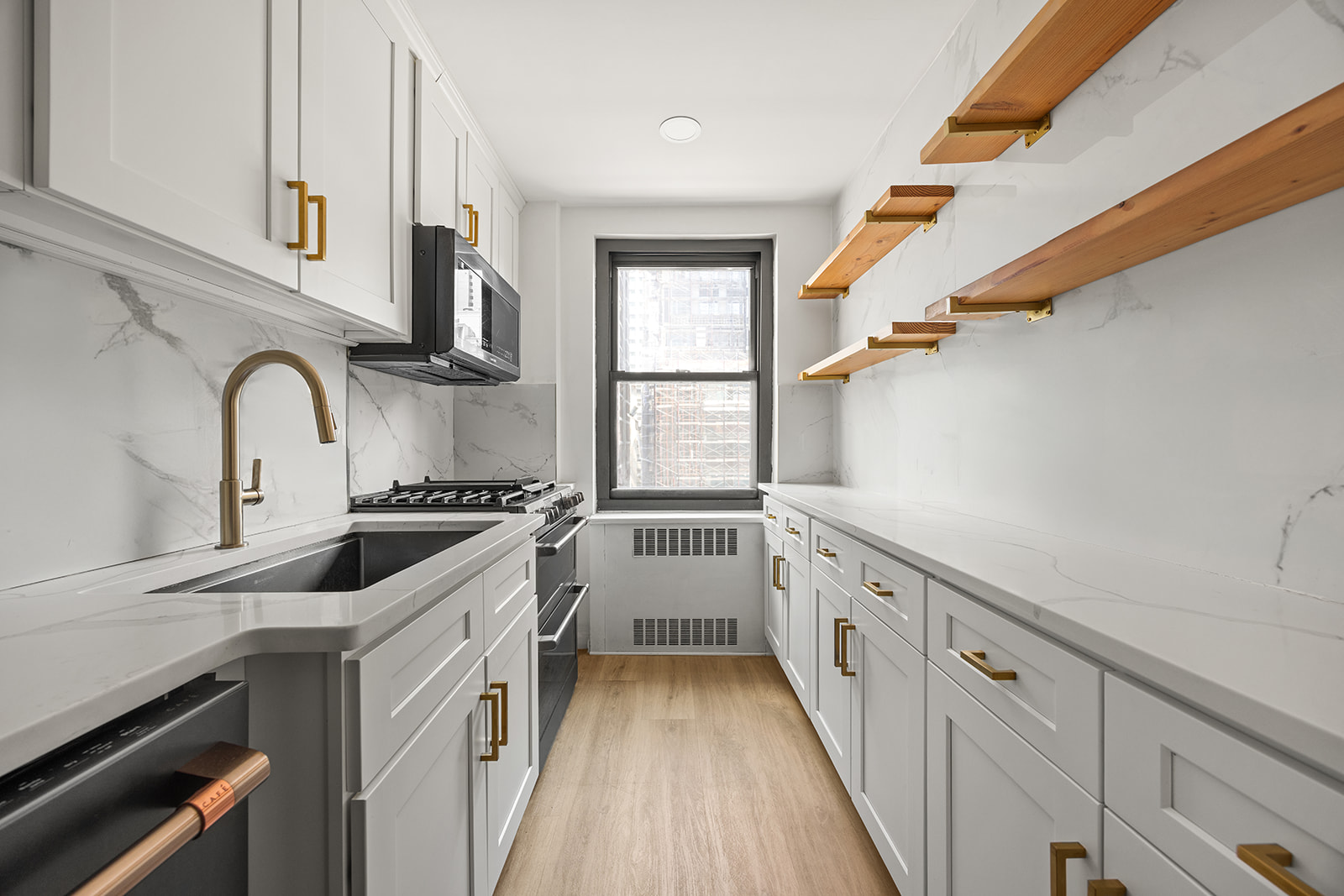 135 East 54th Street, Unit 11G Manhattan, NY 10022 - Photo 3 of 7 a kitchen with granite countertop a stove and a sink