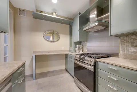 a stove top oven sitting inside of a kitchen