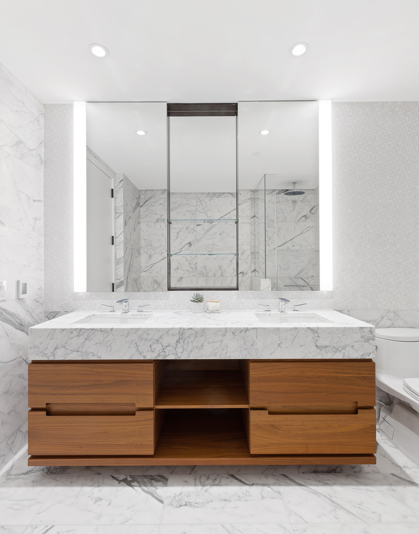 30 Riverside Boulevard, Unit 32G Manhattan, NY 10069 - Photo 6 of 9 a bathroom with a granite countertop sink and a mirror