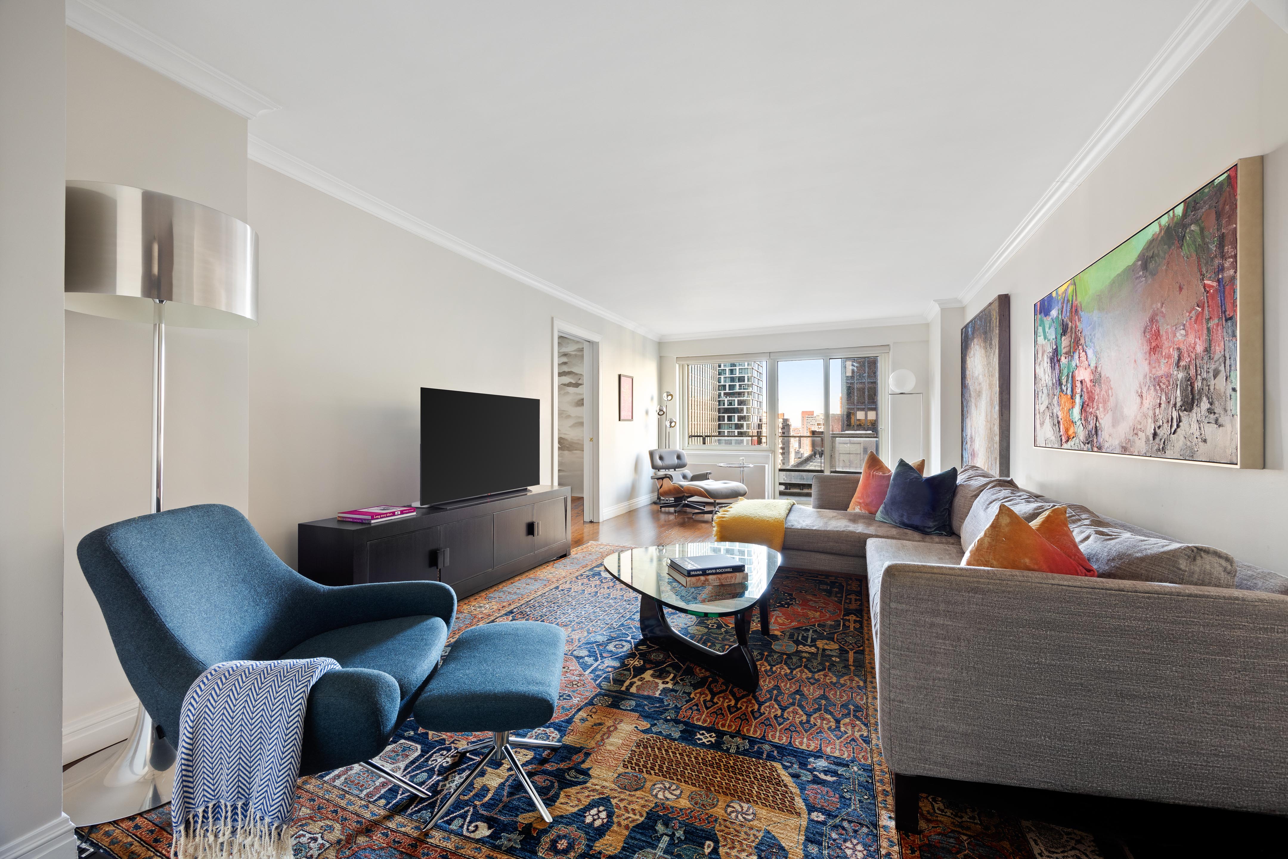 a living room with furniture and a flat screen tv