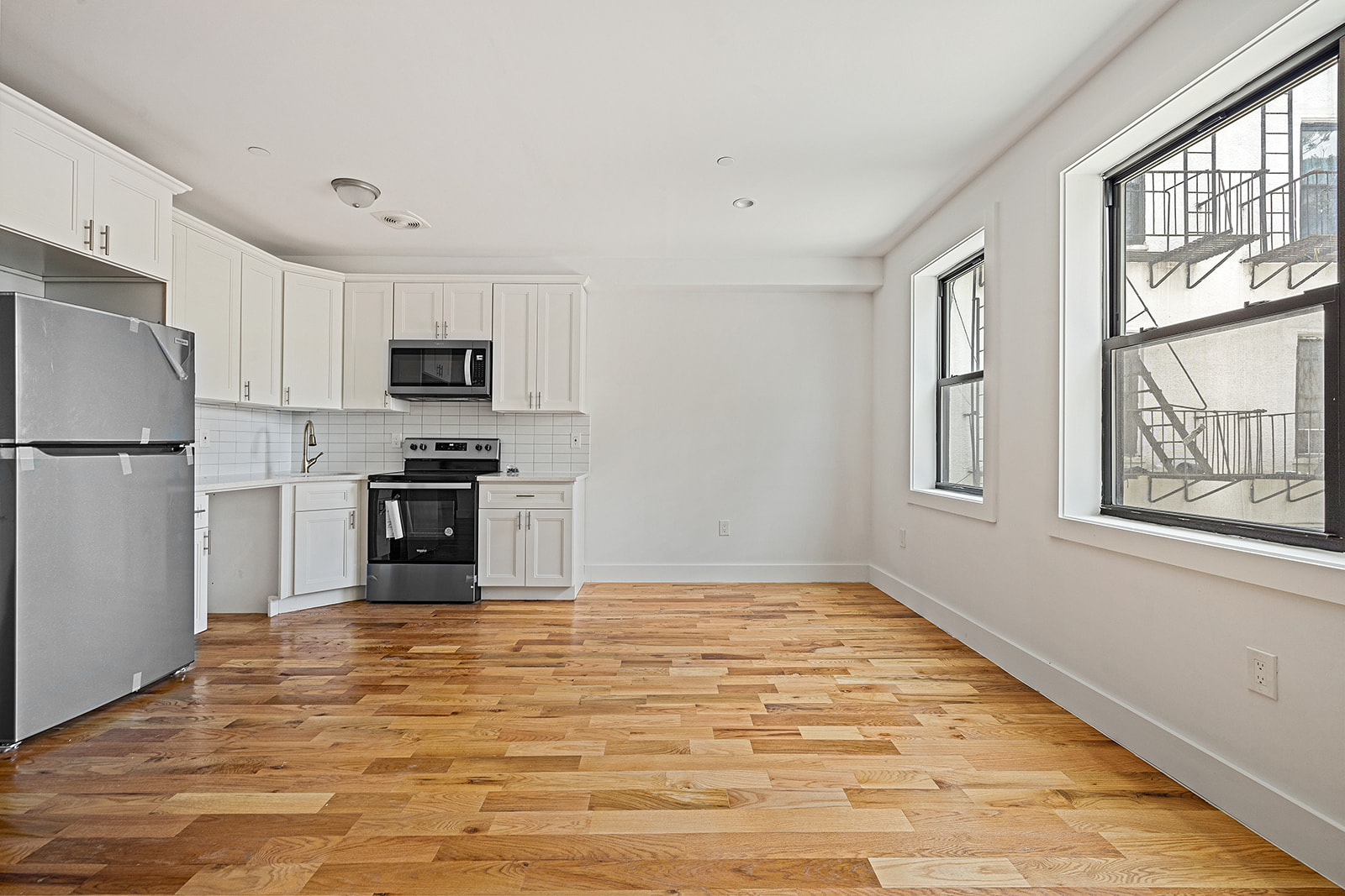 422 East 31st Street Brooklyn, NY 11226 - Photo 2 of 16 a kitchen with stainless steel appliances a refrigerator stove and microwave