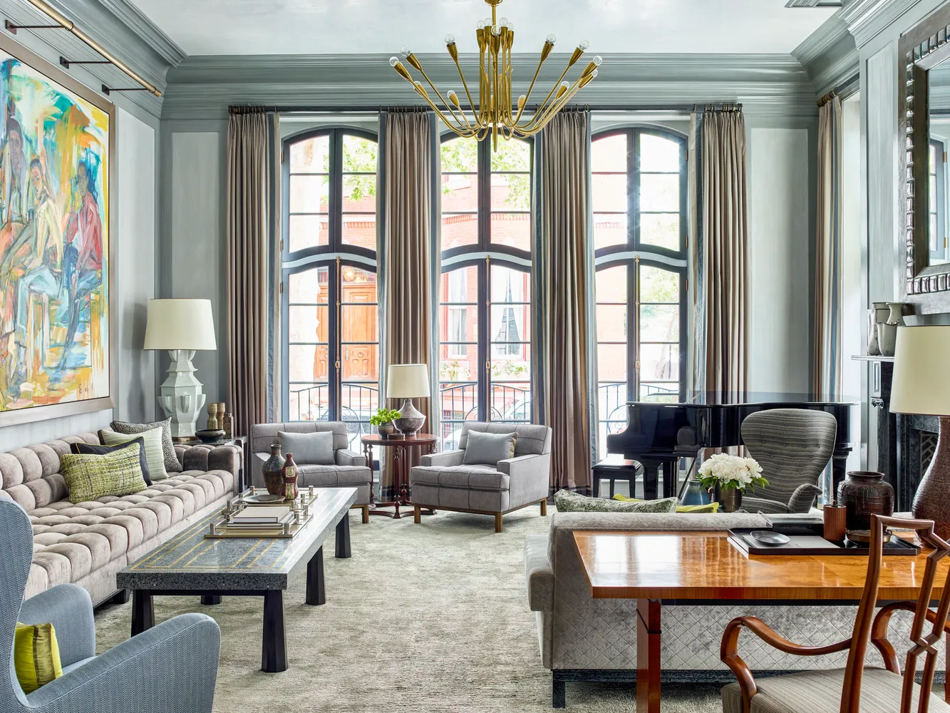 a living room with furniture and large windows