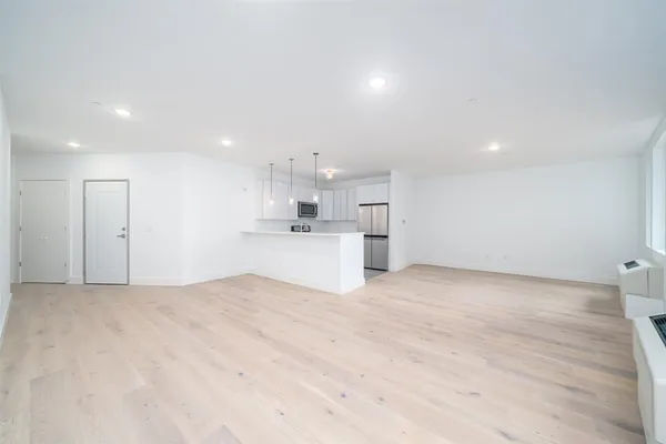 a view of a kitchen with a sink and a refrigerator