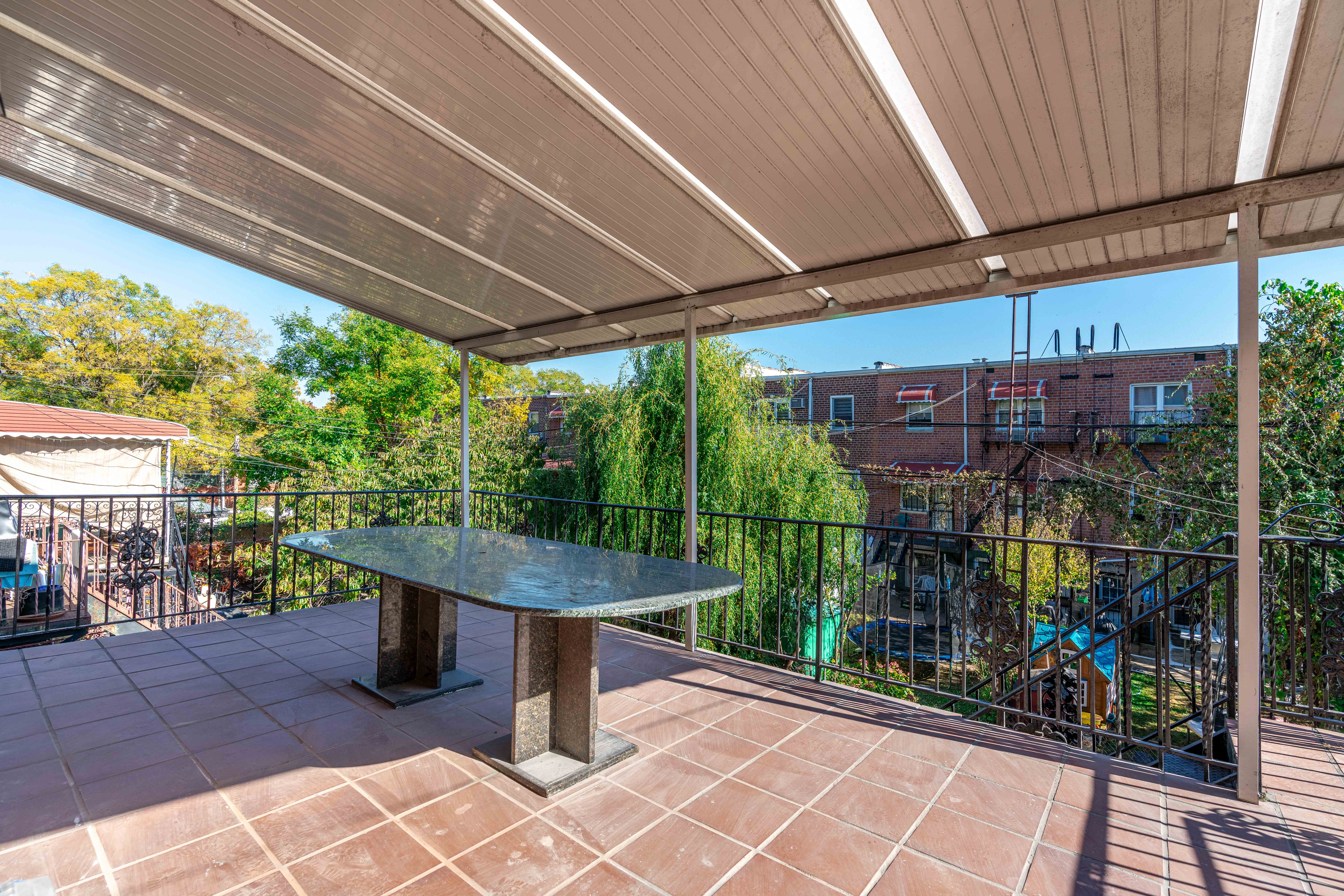 20-15 46th Street, Unit 2 Queens, NY 11105 - Photo 5 of 16 a view of a patio with table and chairs potted plants