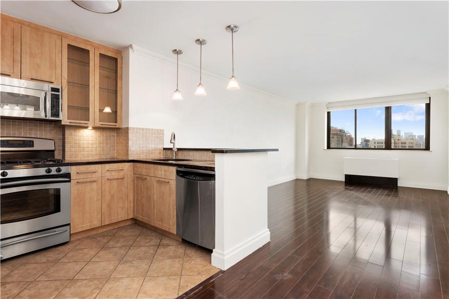 280 Park Avenue South, Unit 24E Manhattan, NY 10010 - Photo 3 of 6 a kitchen with granite countertop a stove a sink and a refrigerator