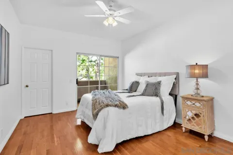 a bedroom with a large bed and a chandelier