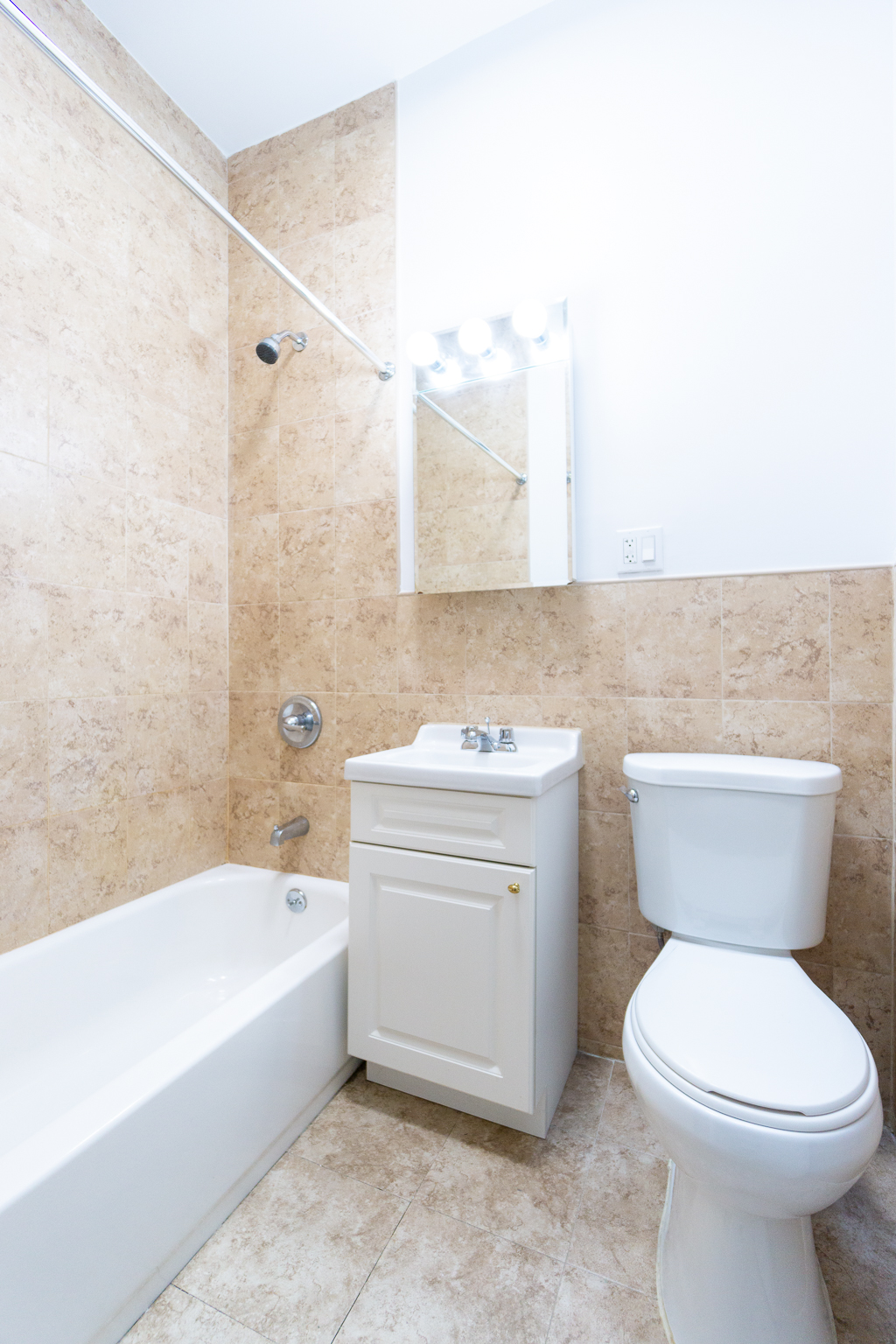 320 West 20th Street, Unit 15 Manhattan, NY 10011 - Photo 5 of 8 a bathroom with a sink a toilet and bathtub