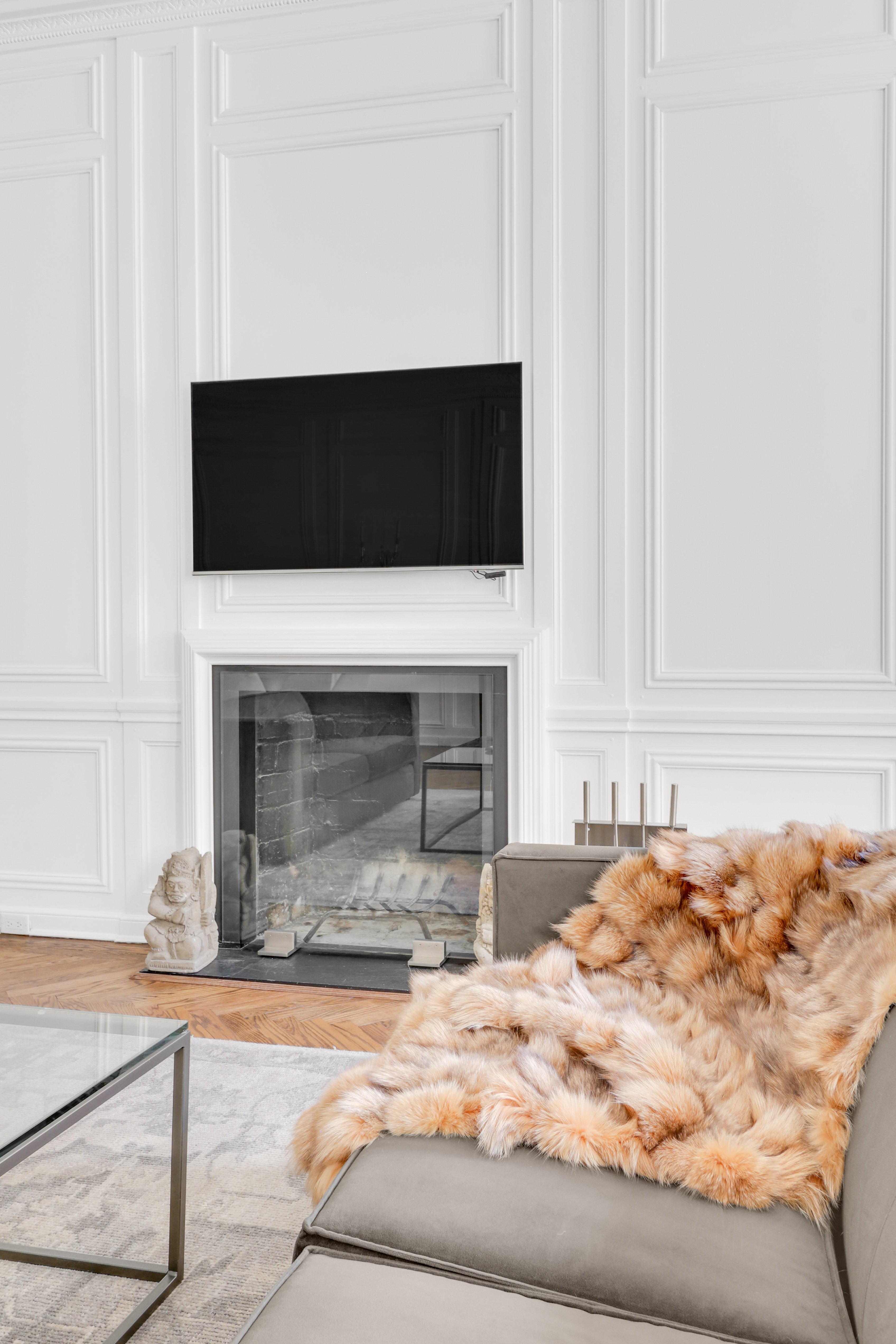 14 East 68th Street, Unit 3 Manhattan, NY 10065 - Photo 3 of 16 a living room with a fireplace and a flat screen tv