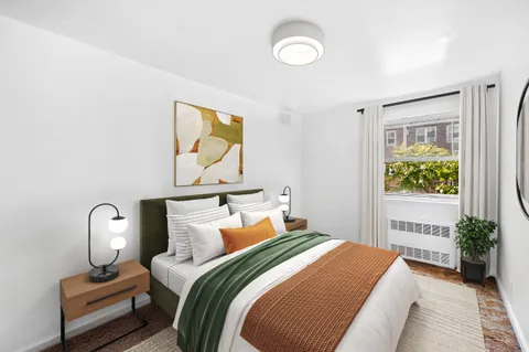 a bedroom with bed and a window