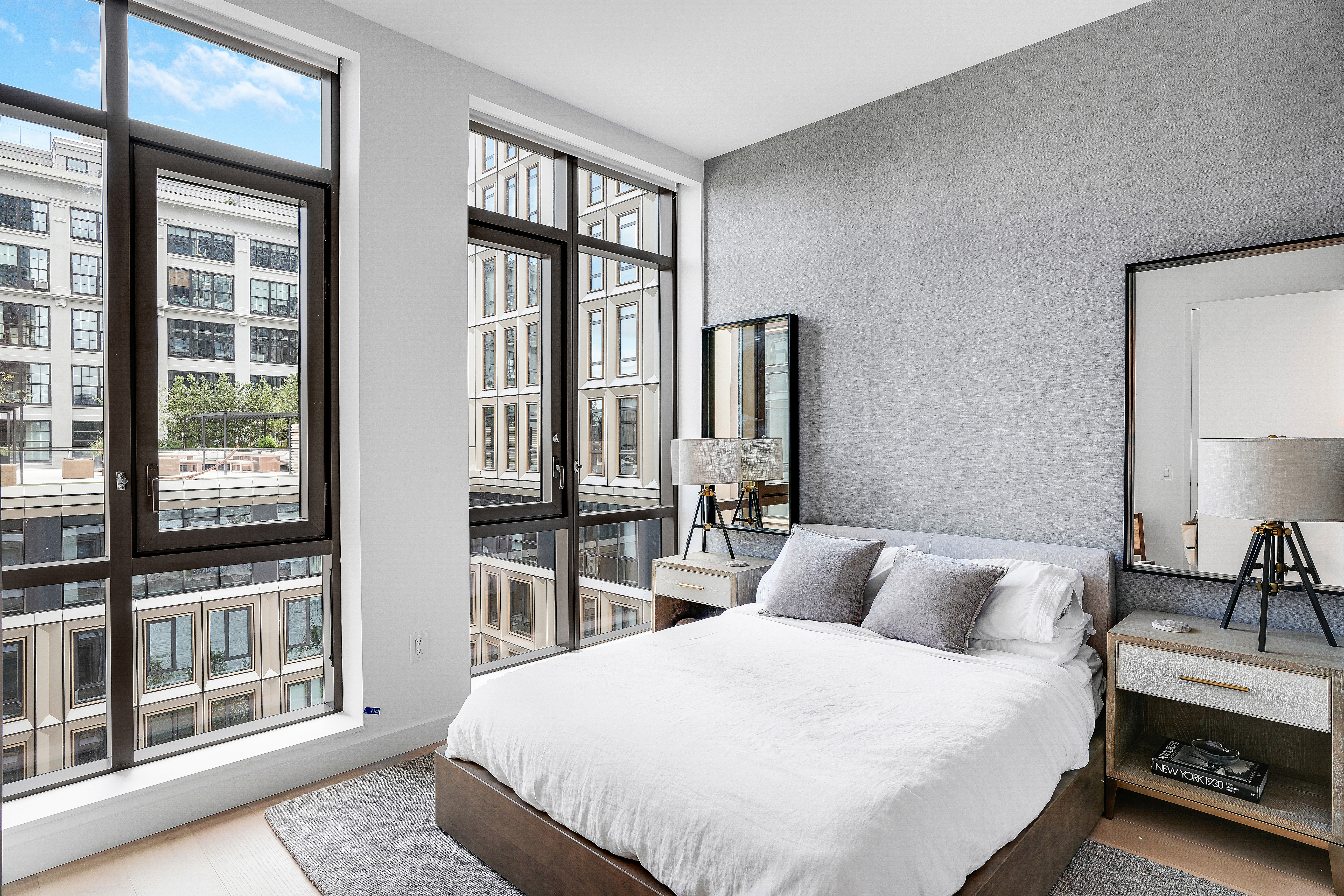 480 Kent Avenue, Unit 9A Brooklyn, NY 11249 - Photo 9 of 33 a bedroom with a bed and a large window with outer view