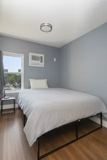 a bedroom with a bed and a window