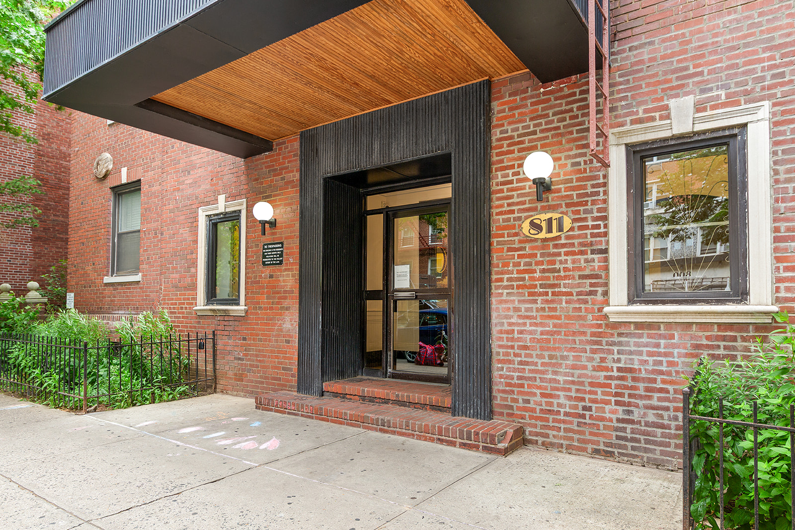 811 Cortelyou Road, Unit 2L Brooklyn, NY 11218 - Photo 9 of 10 a view of a brick house with large windows