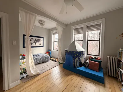 a bedroom with furniture and a window
