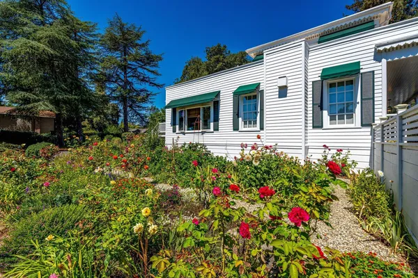a front view of house with yard and trees around