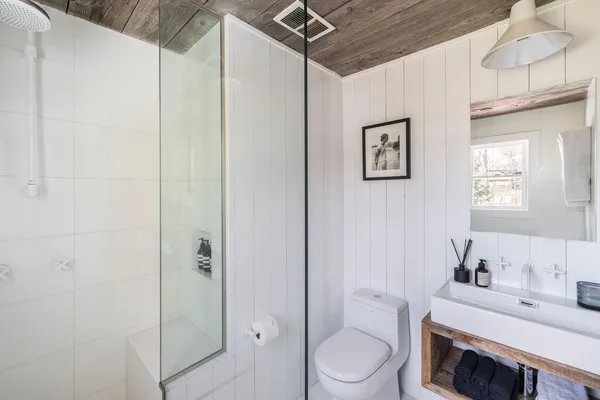 a bathroom with a toilet a sink and shower
