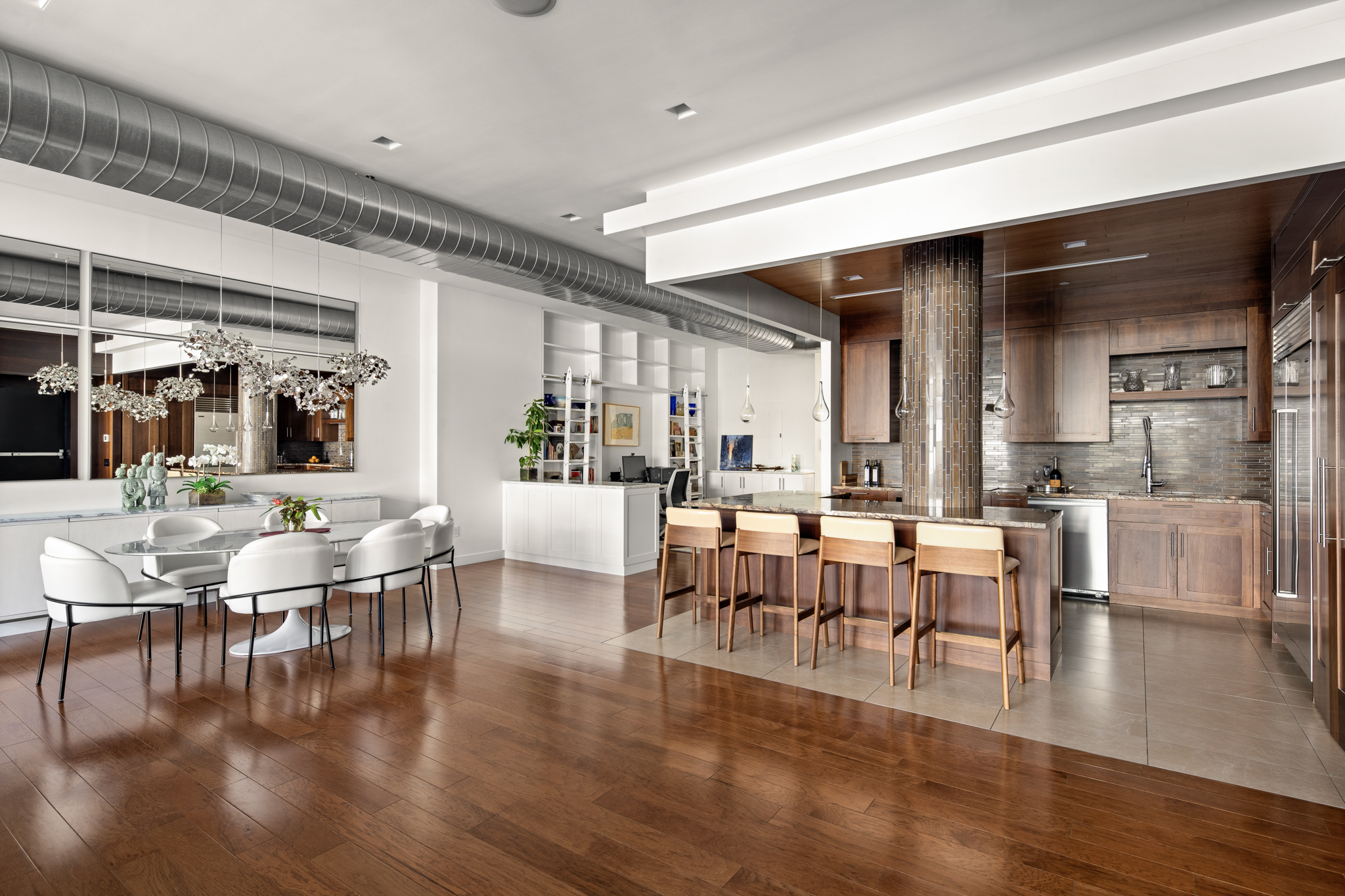 561 Broadway, Unit 10C Manhattan, NY 10012 - Photo 4 of 11 a view of a dining room with lots of furniture and wooden floor