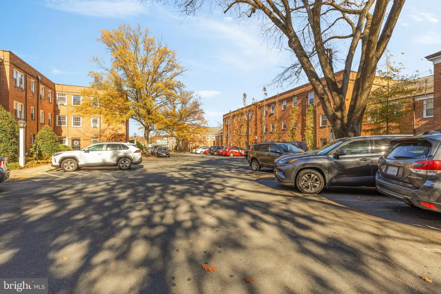 a view of car parked on the side of a street