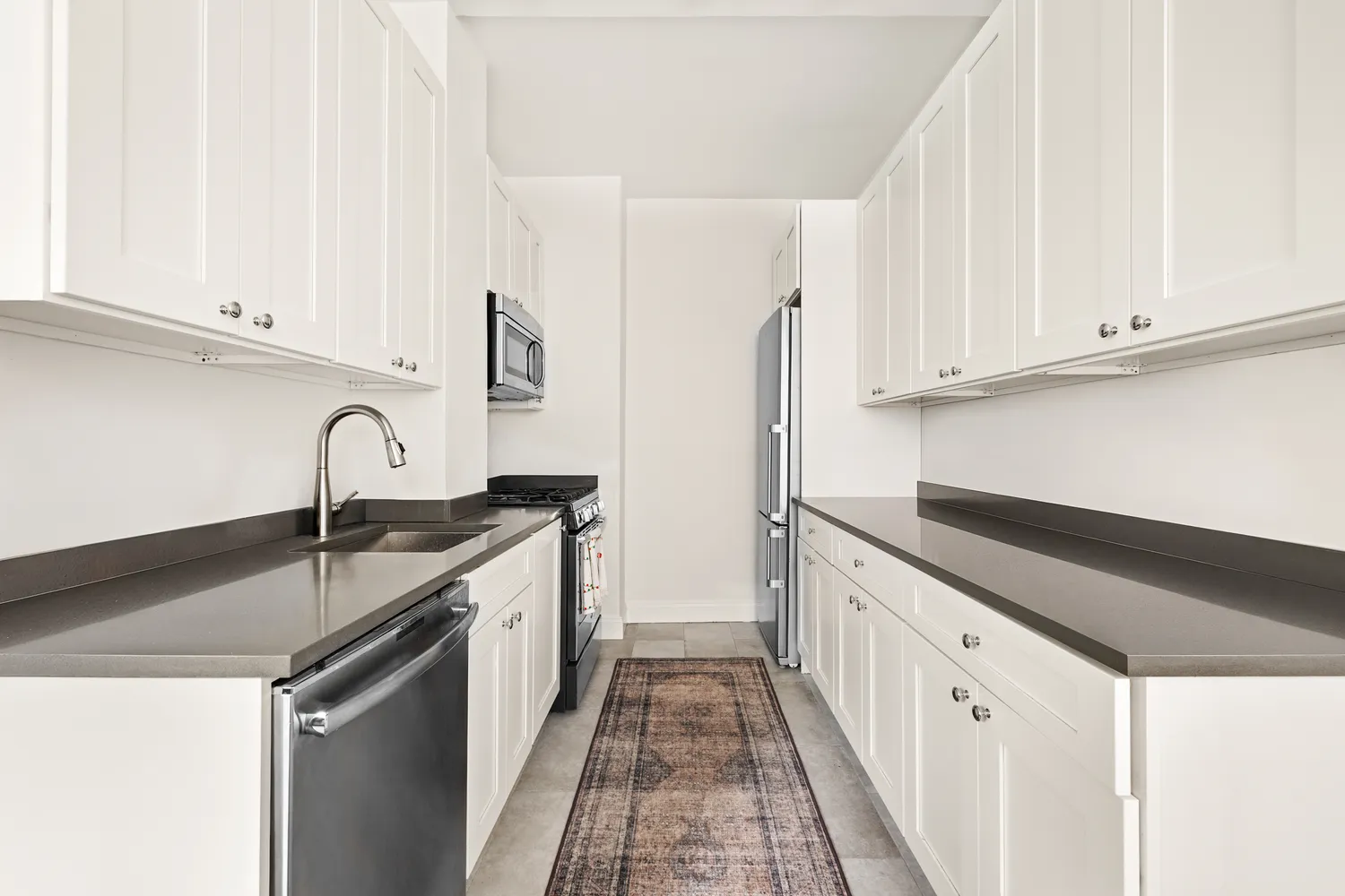 a kitchen with granite countertop a sink and dishwasher