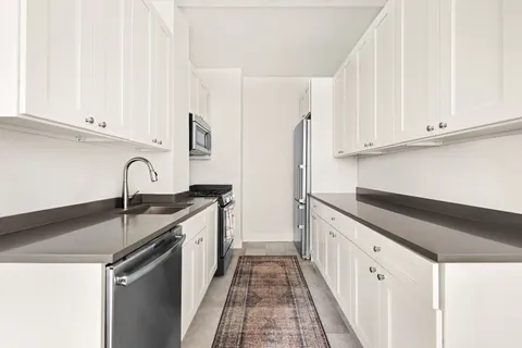 a kitchen with granite countertop a sink and dishwasher