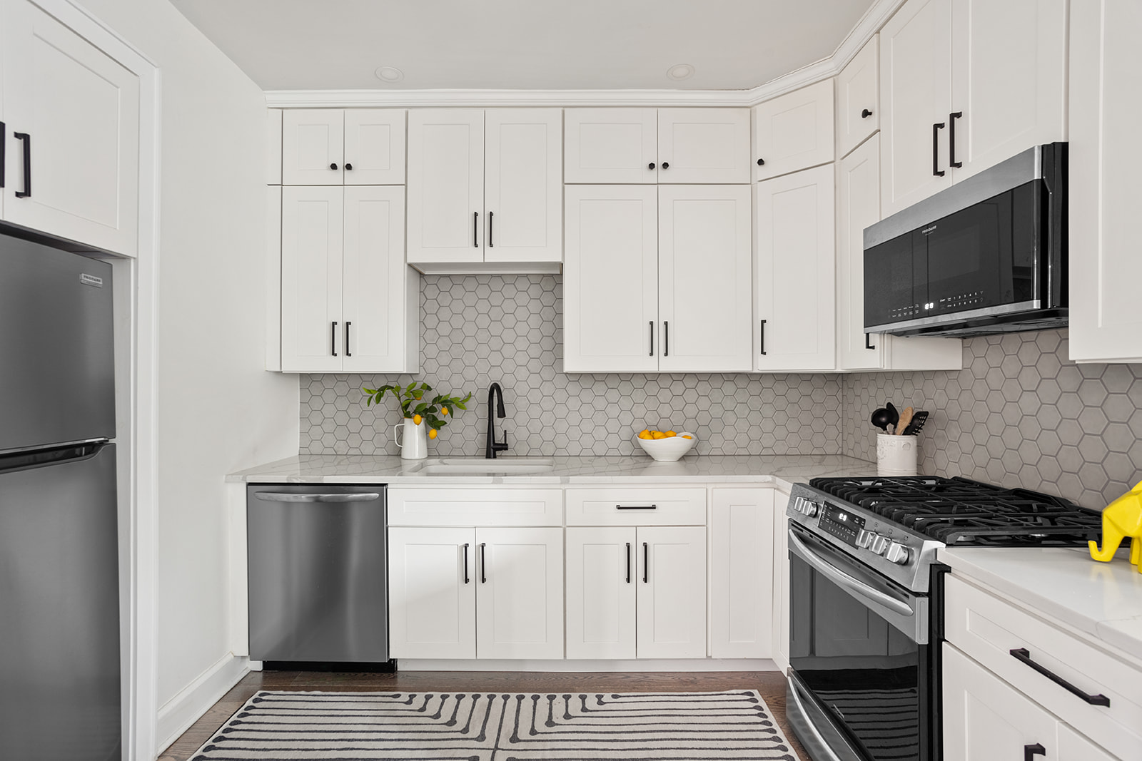 72-17 34th Avenue, Unit 1P Queens, NY 11372 - Photo 6 of 14 a kitchen with stainless steel appliances granite countertop a sink a stove and a refrigerator