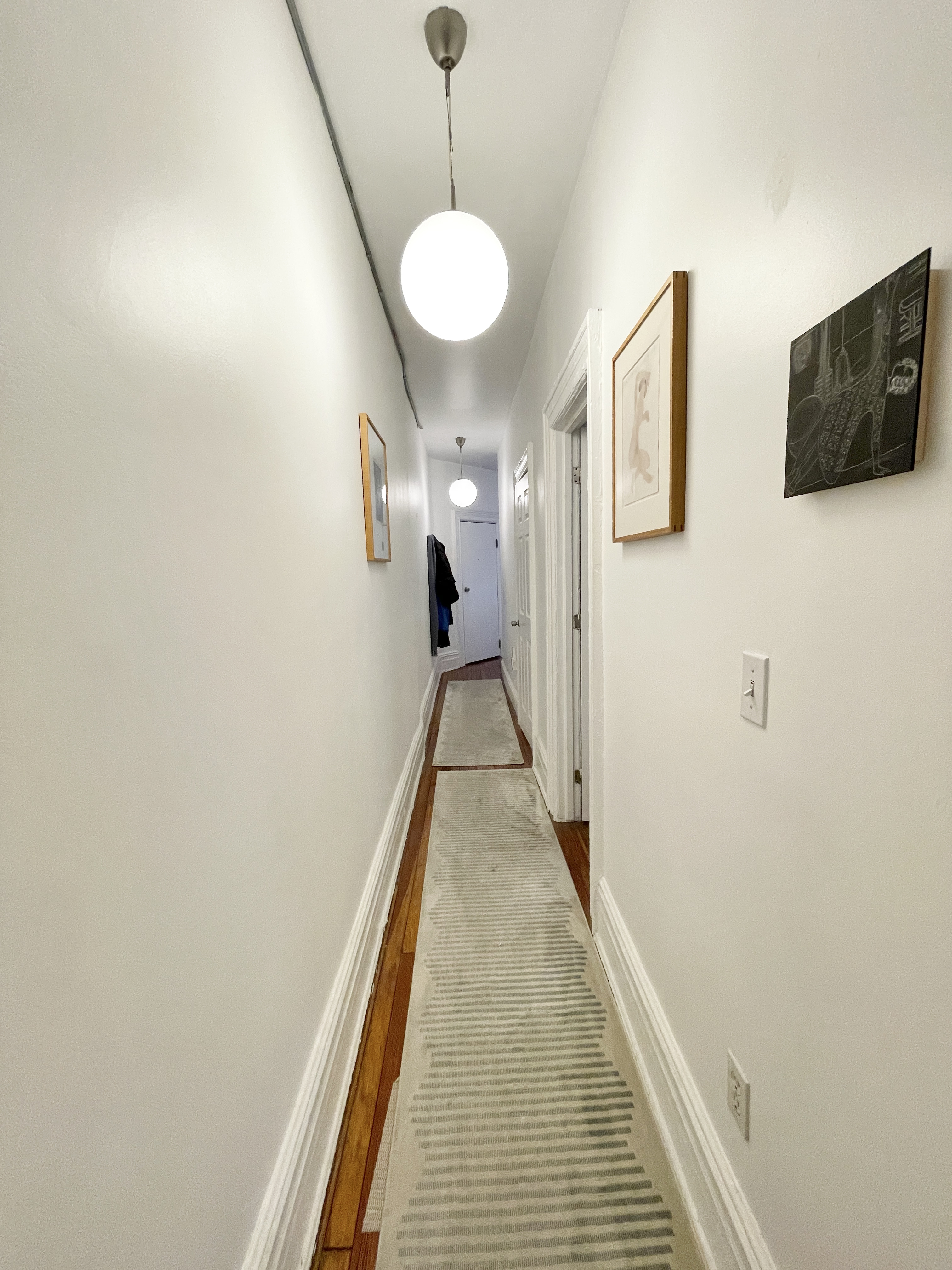 447 Jefferson Avenue, Unit 3L Brooklyn, NY 11221 - Photo 10 of 13 a view of a hallway with wooden floor and staircase