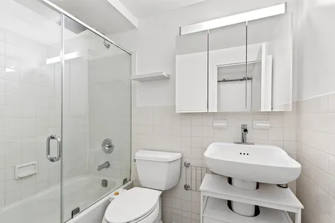 a bathroom with a sink toilet and shower