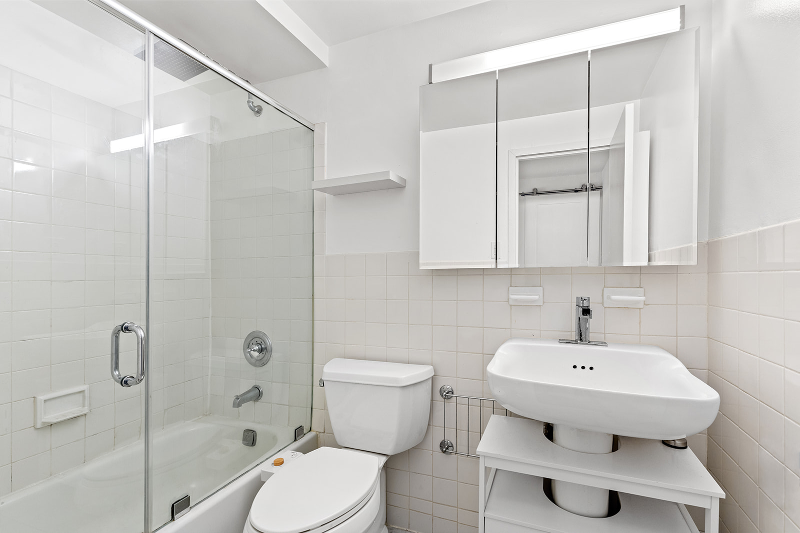 65 Cooper Square, Unit 3A Manhattan, NY 10003 - Photo 5 of 7 a bathroom with a sink toilet and shower