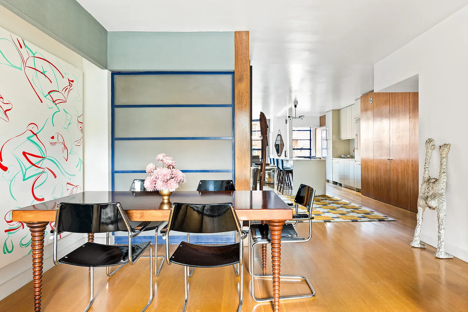 a living room with furniture and a painting on the wall