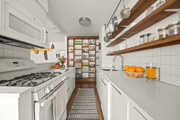 a kitchen with stainless steel appliances a stove a sink and a refrigerator