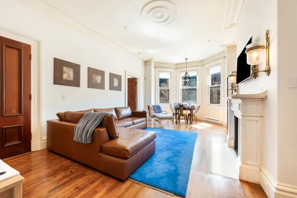 a living room with furniture a flat screen tv and a fireplace