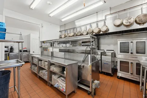 a kitchen with stainless steel appliances granite countertop a stove and a sink