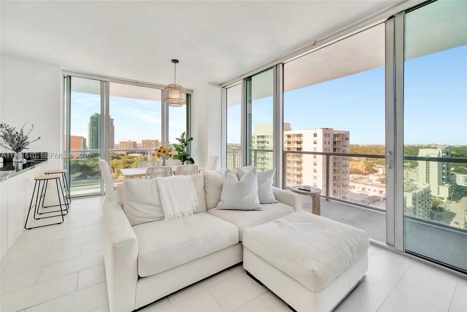 79 Southwest 12th Street, Unit 2201S Miami, FL 33130 - Photo 2 of 33 a living room with furniture and large windows