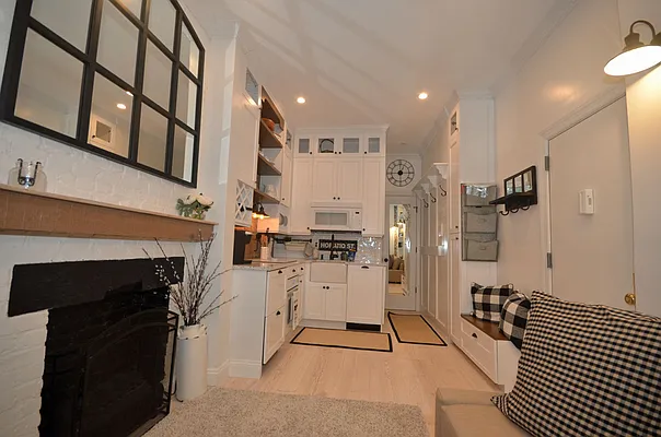 88 Horatio Street, Unit 1C Manhattan, NY 10014 - Photo 5 of 9 a kitchen with stainless steel appliances kitchen island granite countertop a refrigerator oven a sink and dishwasher