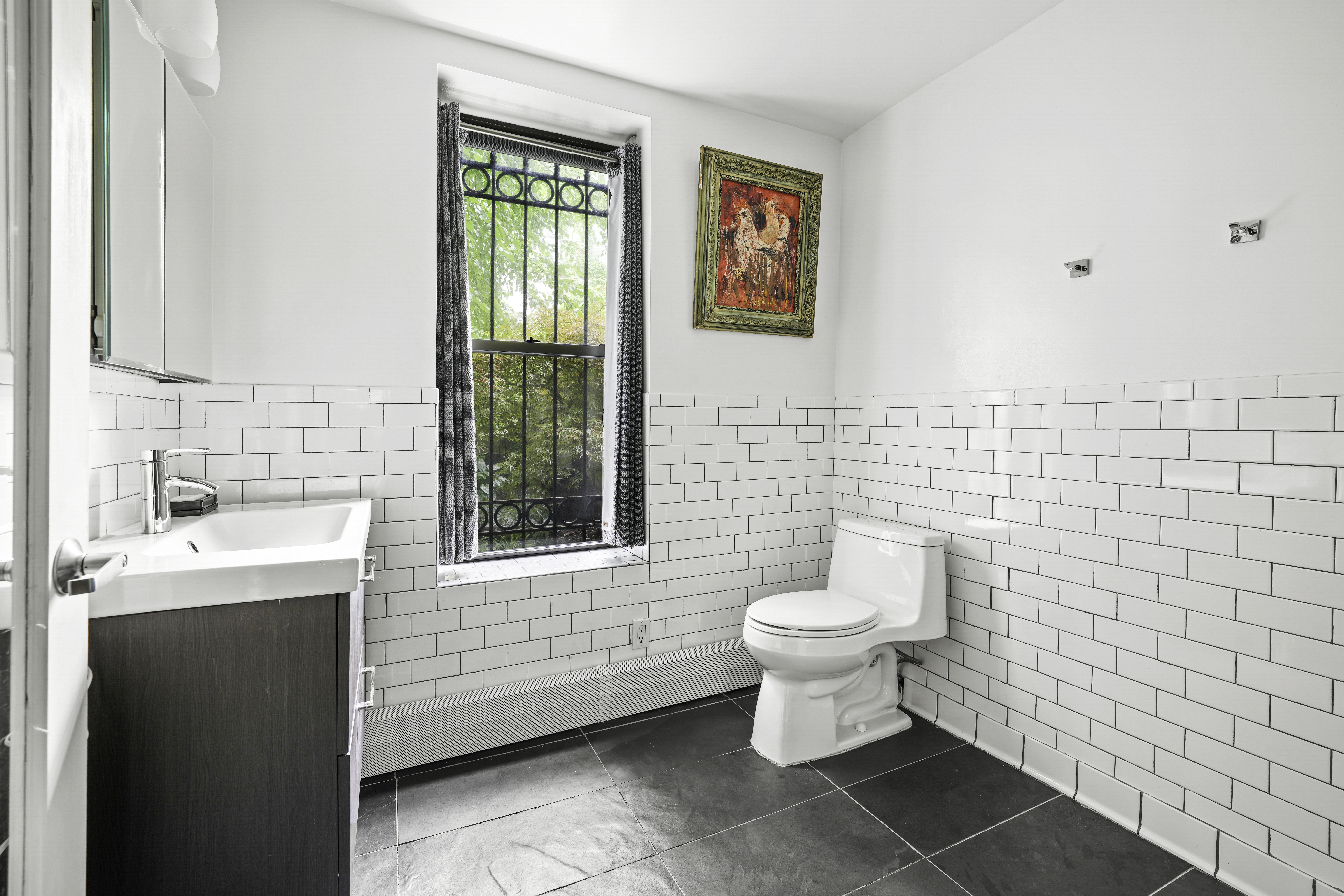 109 West 118th Street Manhattan, NY 10026 - Photo 25 of 31 a bathroom with a toilet sink and mirror